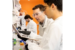 Image Two male scientists looking at a computer screen.